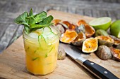 A passion fruit cocktail with mint and lime