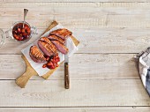 Grilled duck breast with chutney on a wooden board