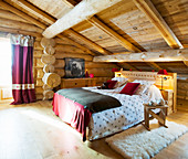 Rustic bedroom in attic of log cabin