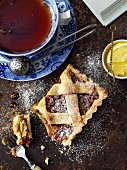 A piece of dried fruit pie and a cup of tea