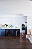American style open plan kitchen with island and bar stools