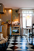 Serving trolley in cosy country-house kitchen with chequered floor