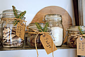 Handwritten labels and fir sprigs on storage jars