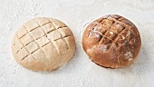 Raw bread and a baked loaf with score marks