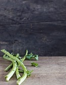 Kale stalks on a wooden surface