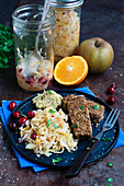 Orange, apple, and cranberry sauerkraut with spiced tofu coated in sesame seeds