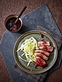 Sliced duck breast with creamed cabbage and sour cherry sauce
