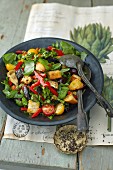 A bread salad with kale and artichokes