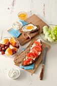 Slices of wholemeal bread topped with fresh cheese and jam, and cottage cheese and tomatoes