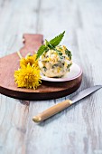 A herb butter ball with dandelions, nettles and chives