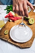 A woman dipping a margarita glass into salt