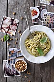 Spaghetti with pesto surrounded by holiday photos (Italy)