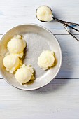 Scoops of melon sorbet and an ice cream scoop