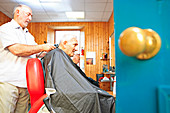 Man with dementia having his hair cut