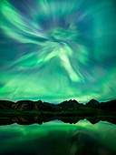 Aurora borealis corona over mountains