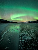 Aurora borealis over a frozen river