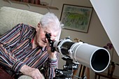 Care home resident with telescope