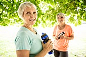 Two women holding sports bottles