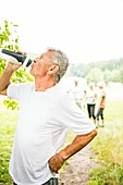 Man drinking water from sports bottle