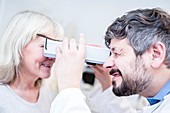 Optometrist performing eye test