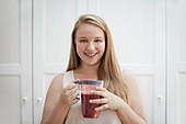 Young woman drinking homemade smoothie
