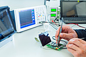 Person soldering in electronics laboratory