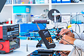 Person working in electronics laboratory