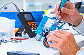 Person working with robotic parts