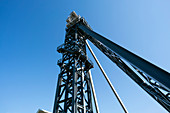 Drilling rig against a clear blue sky