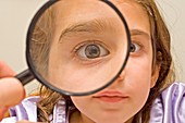 Young girl and magnifying glass