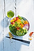 A feel-good Buddha bowl with different vegetables, avocado and salmon