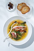 Red mullet with green asparagus, saffron, small Nice olives, and toasted bread (Southern France)
