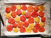 Colourful citrus fruit slices on a baking sheet