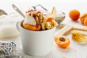Vanilla ice cream with apricots, nuts and jam