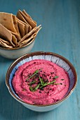 Red beet hummus served with pita crackers