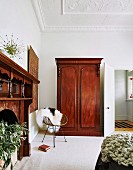 Antique wooden cupboard in the living room with stucco ceiling