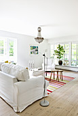 Brightly striped rug in white living room