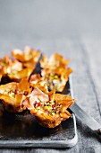 Feta and bacon tartlets with pistachios