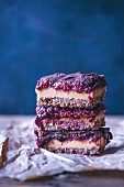 Stack of raw peanut butter and raspberry chia jam bars