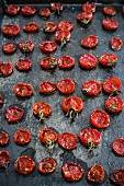 Roasted tomatoes on a black baking sheet