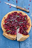 Christmas turkey shortcrust pie topped with cranberries and sage