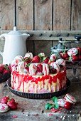 Erdbeer-Mascarpone-Torte dekoriert mit weisser Schokolade und Macarons