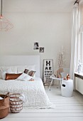 White feminine bedroom decorated with copper-coloured accessories and vintage eye chart