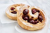 Yeast pastry snails with cherries and almonds
