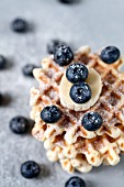 Waffles with banana and blueberry, dusted with powdered sugar