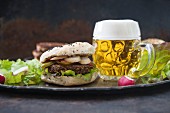 A bean burger in a sesame buns, with radishes and beer (vegan)