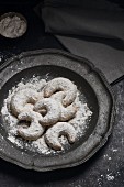 Vanilla horns with powdered sugar on a tin plate