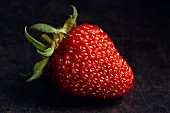 A strawberry on a dark background