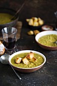 Pea soup with pork knuckle and croutons