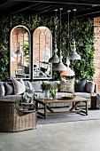 Wicker furniture in front of arched mirrors on climber-covered wall on terrace